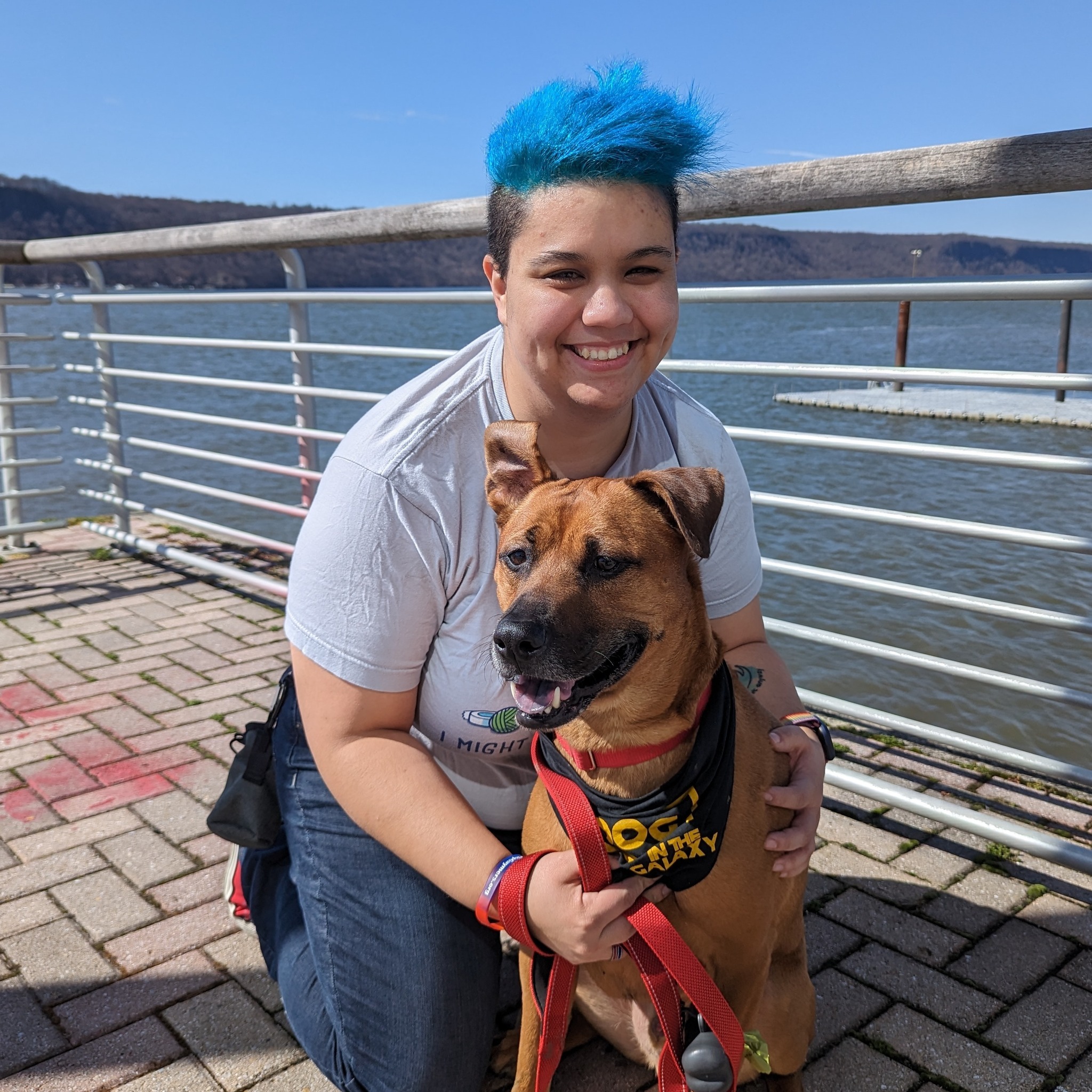 Lin Lin on a pier holding a dog.